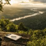Aerial view of Latin American rainforest and river with a surveying instrument in the foreground