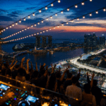 Rooftop party above Marina Bay at dusk with the illuminated street circuit below